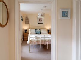 A bedroom with a bed and side tables at Half Moon Cottage in Lyme Regis