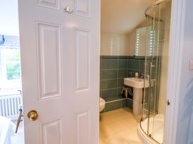 A bathroom with shower and sink at Half Moon Cottage in Lyme Regis