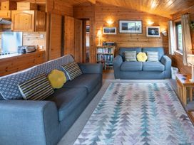 A living room with a sofa, armchair, and coffee table at Watendlath in Keswick
