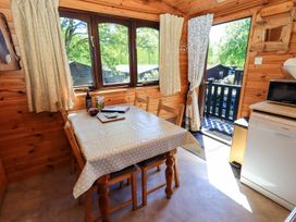 A kitchen with a dining table and chairs at Watendlath in Keswick