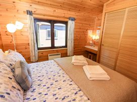 A bedroom with a bed and window at Watendlath in Keswick