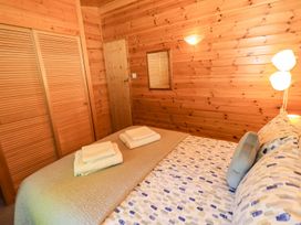 A bedroom with a bed and wardrobe at Watendlath in Keswick