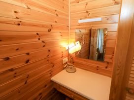 A bathroom with a mirror and lamp at Watendlath in Keswick