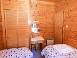 A bedroom with two beds and a desk at Watendlath in Keswick