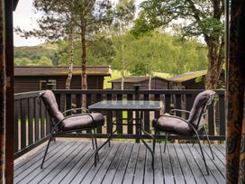 A deck with two chairs and a table at Watendlath in Keswick