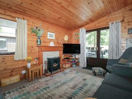 A living room with a television and fireplace at Watendlath in Keswick