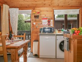 A kitchen with appliances and a dining table at Watendlath in Keswick