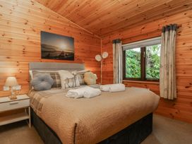 A bedroom with a bed and bedside table at Watendlath in Keswick