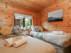 A bedroom with two beds and windows at Watendlath in Keswick