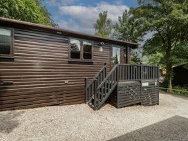 An outdoor view of a wooden cabin with steps and windows at Watendlath in Keswick