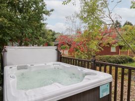 A hot tub on a wooden deck in an outdoor area at Costapacket in Windermere