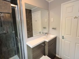 A bathroom with a shower and vanity unit at Costapacket, Grasmere 12, White Cross Bay near Windermere