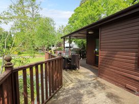 An outdoor deck area with a table and chairs at Costapacket in Grasmere 12, White Cross Bay near Windermere