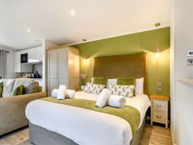A bedroom with a bed and sofa at Pear Tree in Thirsk