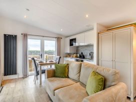 A living room with a sofa and dining area at Pear Tree in Thirsk