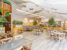 A dining room with tables and chairs at Pear Tree in Carlton Miniott near Thirsk