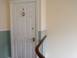 A corridor with a door marked number 6 at The Studio on the Crescent Whitby