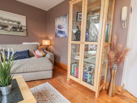 A living room with a sofa and bookshelf at The Studio on the Crescent in Whitby