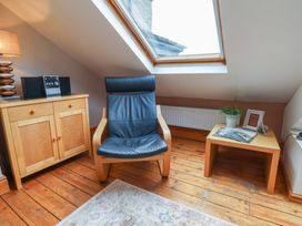 A snug with a chair and furniture at The Studio on the Crescent in Whitby