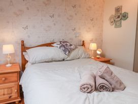 A bedroom with a bed and bedside table at The Studio on the Crescent in Whitby