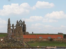 Ruins with graveyard and buildings at The Studio on the Crescent Whitby