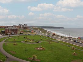 A view of the sea and buildings from a park at The Studio on the Crescent Whitby