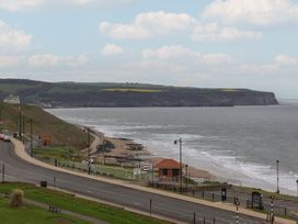 A view of the ocean and shore with cliffs at The Studio on the Crescent Whitby