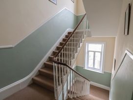 A staircase with a window and frames at The Studio on the Crescent in Whitby