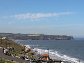 A coastal view with cars parked and the ocean at The Studio on the Crescent in Whitby