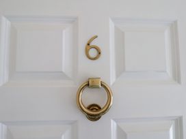A door with number 6 and a knocker at The Studio on the Crescent Whitby