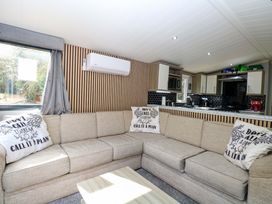 A living room with a sofa and coffee table at Wild Duck Holiday Park in Belton, Norfolk