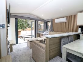 A living room with a sofa and dining table at Wild Duck Holiday Park in Belton, Norfolk