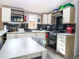 A kitchen with stove and sink at Wild Duck Holiday Park in Belton, Norfolk