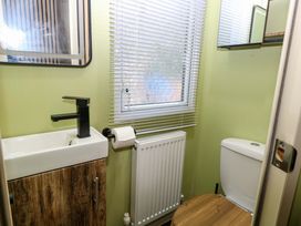 A bathroom with a sink, toilet, and radiator at Wild Duck Holiday Park, Belton, Norfolk