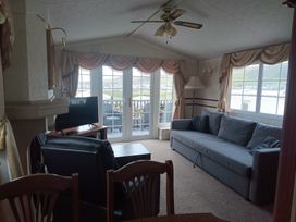 A living room with a sofa and television at Clarach Bay Holiday Village - Holiday Accommodation 10536, Aberystwyth