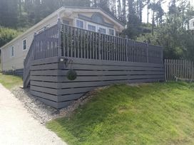 An outdoor area with a house, deck, and steps at Clarach Bay Holiday Village - Holiday Accommodation 10536 Aberystwyth
