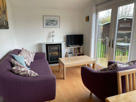 A living room with a sofa and television at Hoburne Cotswolds - Holiday Accommodation 10757 Cirencester