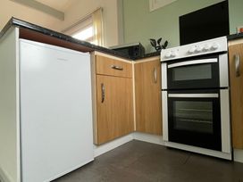 A kitchen with a fridge, oven, and microwave at Hoburne Cotswolds - Holiday Accommodation 10757 Cirencester