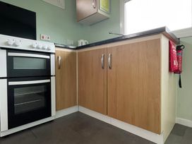 A kitchen with an oven and cabinets at Hoburne Cotswolds - Holiday Accommodation 10757, Cirencester