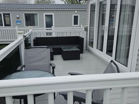 An outdoor lounge area with furniture at Primrose Valley Holiday Park - Holiday Accommodation 10790 in Filey