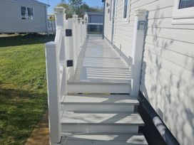 A pathway with steps and handrails at Primrose Valley Holiday Park - Holiday Accommodation 10790, Filey