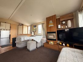 A living room with a sofa and television at Cala Gran Holiday Park - Holiday Accommodation 10830 in Fleetwood