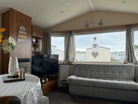 A living room with a TV and sofa at Cala Gran Holiday Park - Holiday Accommodation 10830, Fleetwood