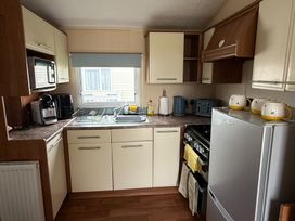 A kitchen with appliances and fixtures at Cala Gran Holiday Park - Holiday Accommodation 10830, Fleetwood