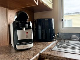 A coffee machine and air fryer on the kitchen counter at Cala Gran Holiday Park - Holiday Accommodation 10830 in Fleetwood