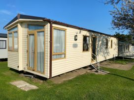 A mobile home with a door and windows at Cayton Bay Caravan Park - Holiday Accommodation 11727 Scarborough