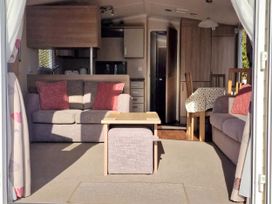 A living room with a sofa and dining area at The Crest, Filey (private land) - Holiday Accommodation 11967