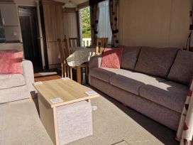 A living room with a sofa and dining table at The Crest, Filey (private land) - Holiday Accommodation 11967, Filey