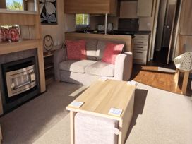 A living room with a sofa and coffee table at The Crest, Filey (private land) - Holiday Accommodation 11967 Filey