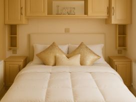 A bedroom with a bed and storage units at Combe Haven Holiday Park - Holiday Accommodation 12122, St. Leonards-on-Sea